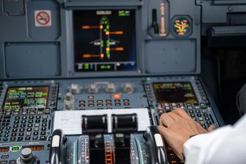Pilot in command setting control panel in cockpit Stock-Fotos
