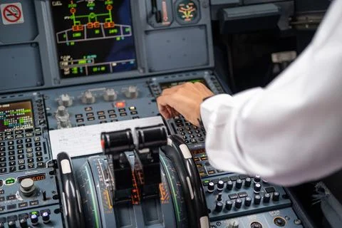 Pilot in command setting control panel in cockpit Foto stock