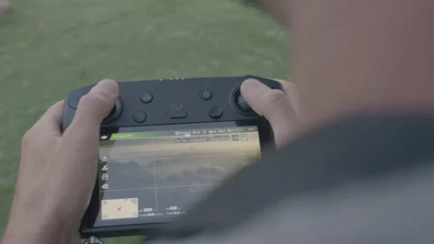 A pilot directs his drone Stock Footage 230862106