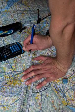 Pilot is doing his pre flight calculation on a navigation map 25.3.2021 Fotos de archivo