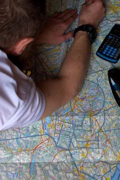 Pilot is doing his pre flight calculation on a navigation map 25.3.2021 Fotos de archivo