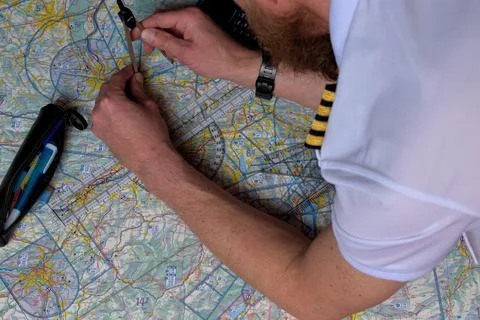 Pilot is doing his pre flight calculation on a navigation map 25.3.2021 Fotos de archivo