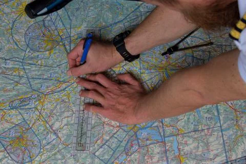 Pilot is doing his pre flight calculation on a navigation map 25.3.2021 Fotos de archivo