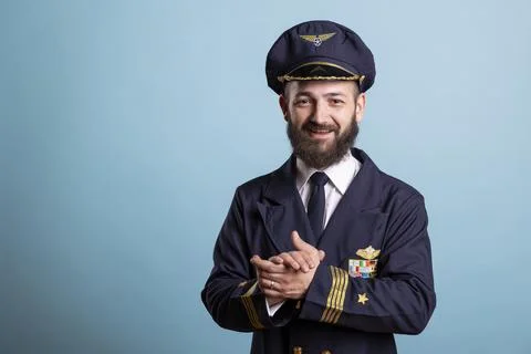 Pilot doing studio portrait over blue background with relaxed smile Stock Photos