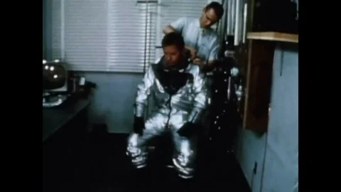 A pilot dons a spacesuit and a rocket sled is shown and a nose cone is used to Video stock 93331375