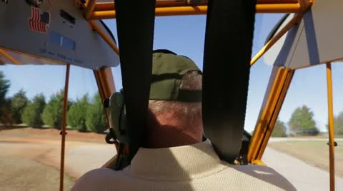 Pilot driving on land in plane Stock Footage 22100609