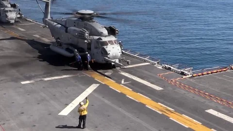 Pilot entering cockpit of CH-53 Super Stallion aboard USS Bonhomme Richard LHD 6 Stock Footage 84639836