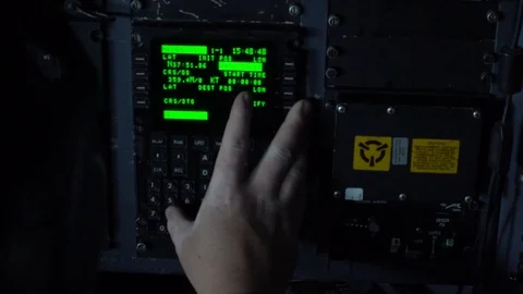 Pilot entering data using keypad on C-130 cockpit controls Stock Footage 113610796