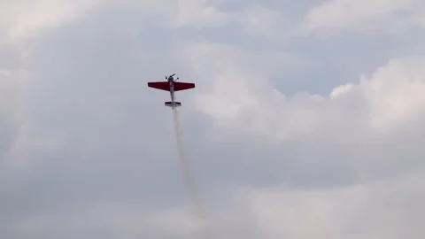 A pilot flies an aerobatic propeller plane in the sky Stock Footage 284582362