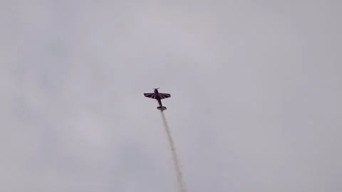 A pilot flies an aerobatic propeller plane in the sky Stock Footage 284583070