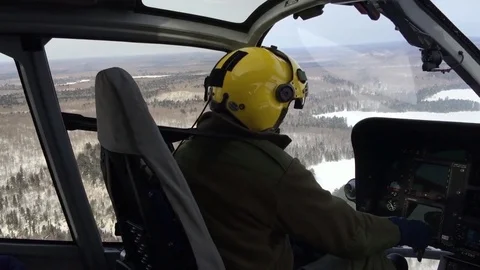 Pilot flying helicopter Stock Footage 82020140