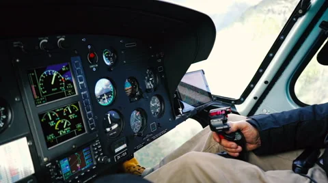 Pilot flying helicopter using cyclic joystick control Stock Footage 65077102