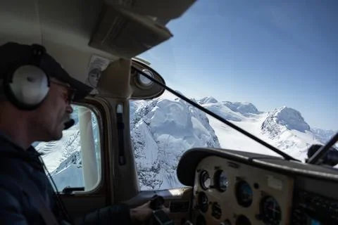 Pilot flying plane over Mountain Denali in Alaska Stock Photos