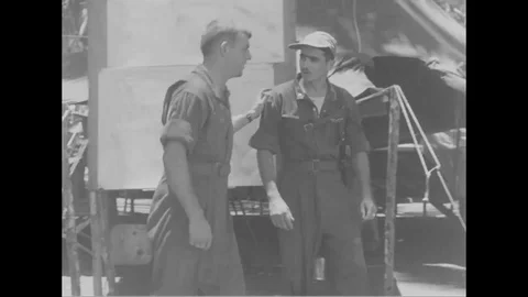 Pilot gets ready for mission and crew members install camera in aircraft - 1944 Stock Footage 99786391
