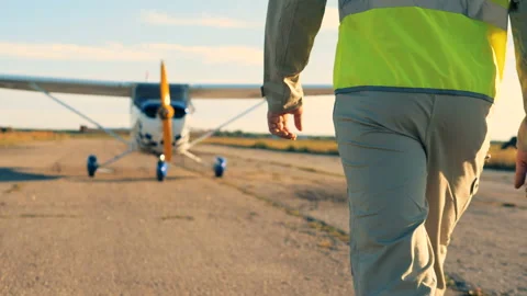 Pilot going on a runway, back view. Professional pilot coming to his plane Stock Footage 95525208