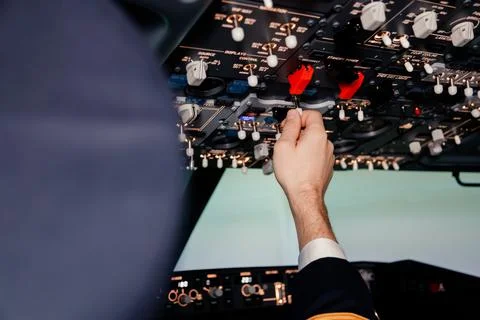 Pilot hand is controlling plane toggle switches to fly take off and landing Stock Photos