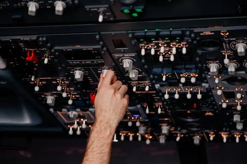 Pilot hand is controlling plane toggle switches to fly take off and landing Stock Photos