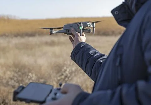 Pilot hand launching drone drone ready to take off. modern unmanned technolog Stock Photos
