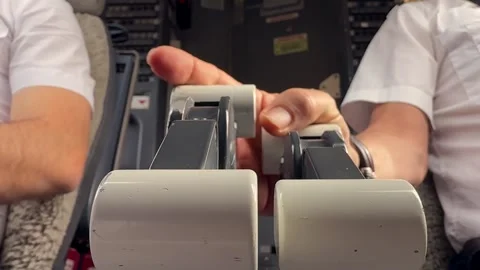 Pilot Hands Adjusting Throttle Controls in a Jet Cockpit Close-up View. Stock Footage 331640847