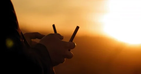 Pilot hands using drone remote control at sunset 4K Stock Footage 83672416