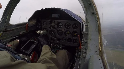 The pilot hold and control helm. Combat plane fly over field and turn to reft. Stock Footage 118677683