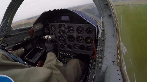 Pilot hold and control helm. Jet plane fly very quickly and low above ground. Stock Footage 118677716