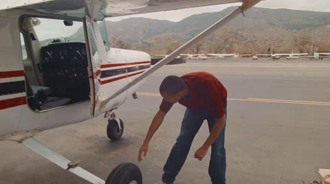Pilot inspecting plane Stock Footage 60271548