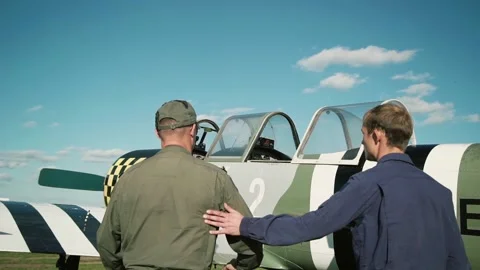 The pilot with the instructor approaches the plane Stock Footage 147715980