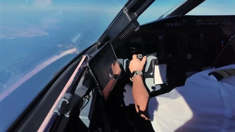 Pilot. with the Left Hand on the Flight Controls Flying Over a Coastal Stock Footage 341128840