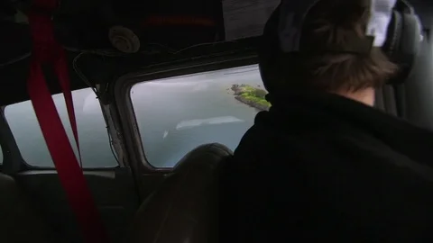 Pilot looking at lake while driving a airplane Stock Footage 83304720