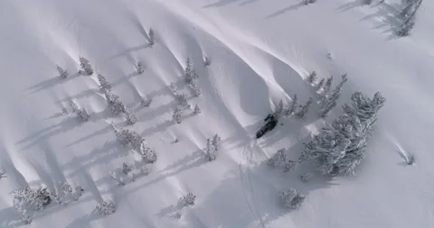 The pilot of a mountain snowmobile is stuck in a winter forest Stock Footage 149040686