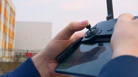 The pilot moves the left joystick on the main control panel of the drone. The Stock-Footage 154875728