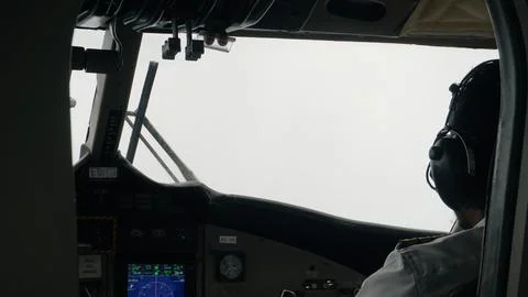 Pilot navigating airplane through dense fog in the cockpit Foto stock