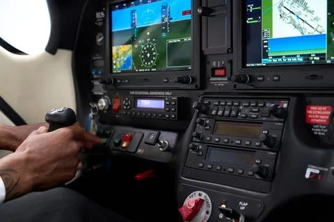 Pilot operating aircraft controls and avionics in cockpit during flight training Stock Photos