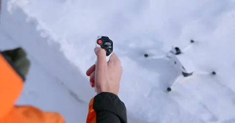 Pilot Operating Motion Controller for Drone take off in Snow Stock Footage 343928652