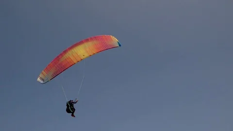 Pilot paraglides on sandy beach Stock Footage 79628016