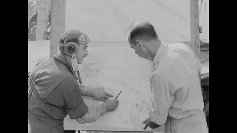 Pilot photographer and S-2 officer points on map and officer makes a call - 1944 Stock Footage 99786454