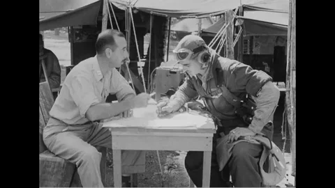 Pilot photographer points out enemy activity over map - 1944 Stock Footage 99786442