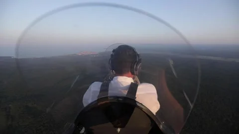 Pilot pioloting during summer sunset Stock Footage 146045349