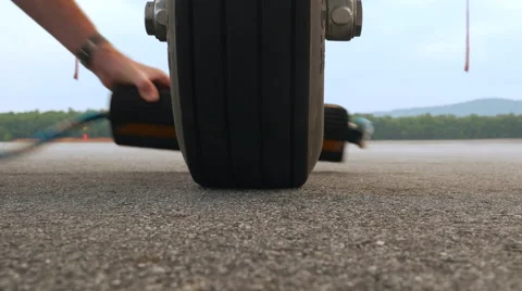 Pilot Places Wheel Chock Underneath Jet Aircraft 4K UHD Stock Footage 43236125