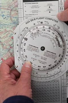 Pilot plots a flight on a sectional map for a vector from one airport to another Fotos de archivo