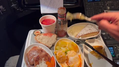 Pilot POV of a crew meal inside the cockpit in a real time flight at Stock Footage 282368824