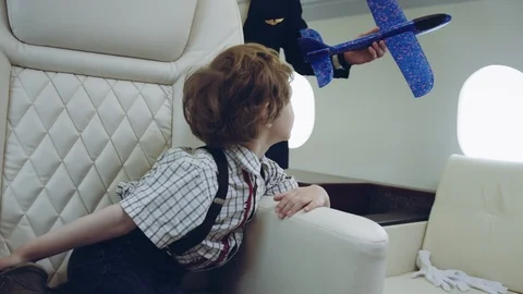 Pilot presenting for boy blue plane toy, imagination dreaming of being a pilot Stock Footage 111069416