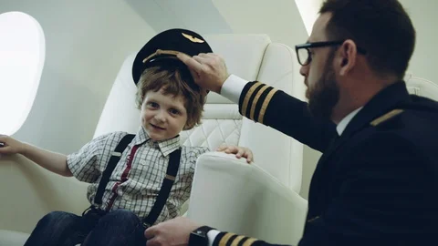 Pilot presenting for a boy his uniform cap, imagination dreaming of being a Stock Footage 111068724