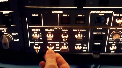 Pilot pressing on illuminated buttons on a plane for a flight simulator Video stock 237084676