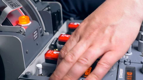 A pilot pulls out a lever in a dashboard, close up. Video stock 88610392