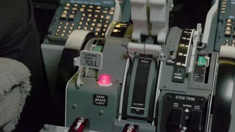Pilot pushes brake lever on control panel slowing down plane Stock Footage 281315241