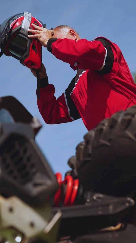 The pilot puts on a helmet, the buggy pilot, vertical shooting Stock Footage 280978965