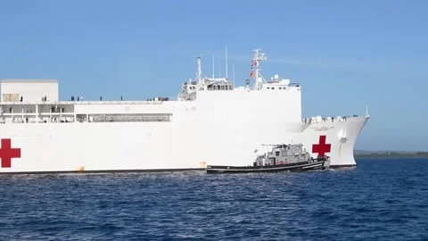 Pilot ship guiding U.S. Navy hospital ship USNS Comfort (T-AH-20)  Stockbeeldmateriaal 227138715