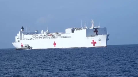 Pilot ship sailing close to U.S. Navy hospital ship USNS Comfort (T-AH-20)  Stock Footage 227138698